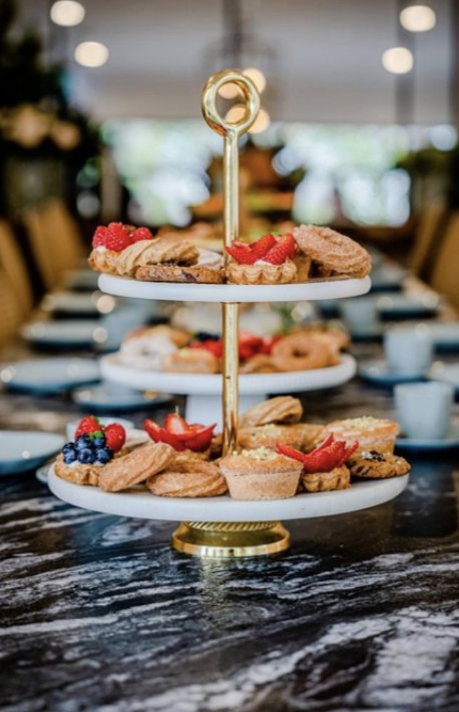 High tea tiered stand with pastries, tarts and scones